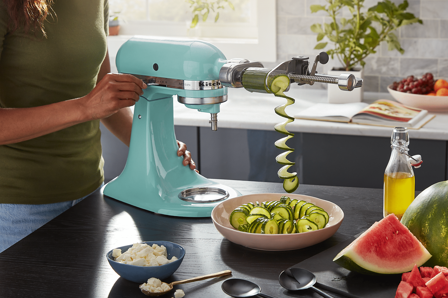 A teal KitchenAid® Stand Mixer and zucchini spirals.